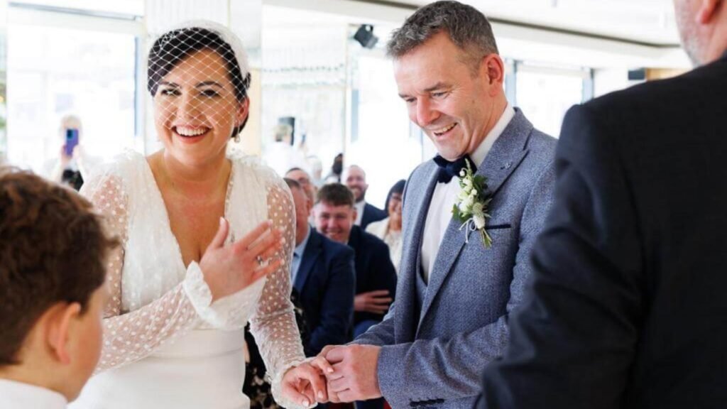 A couple sharing a relaxed, emotional moment during their wedding ceremony in Ireland, smiling and laughing as nerves fade.moment