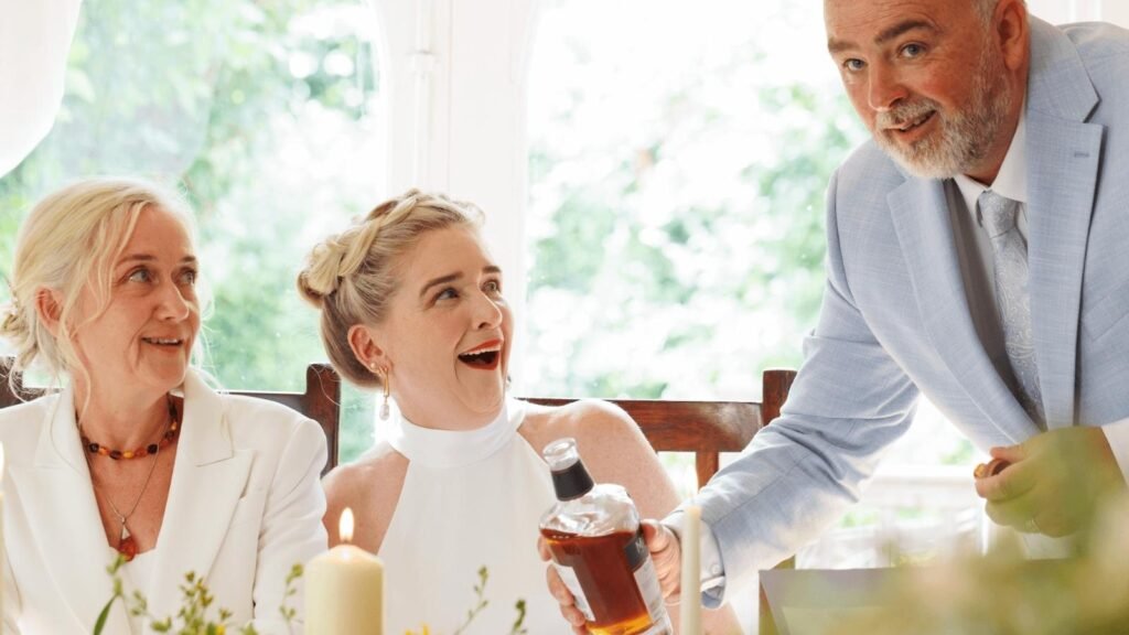 A warm, informal wedding ceremony in Ireland, showing laughter and connection between the couple and celebrant.
